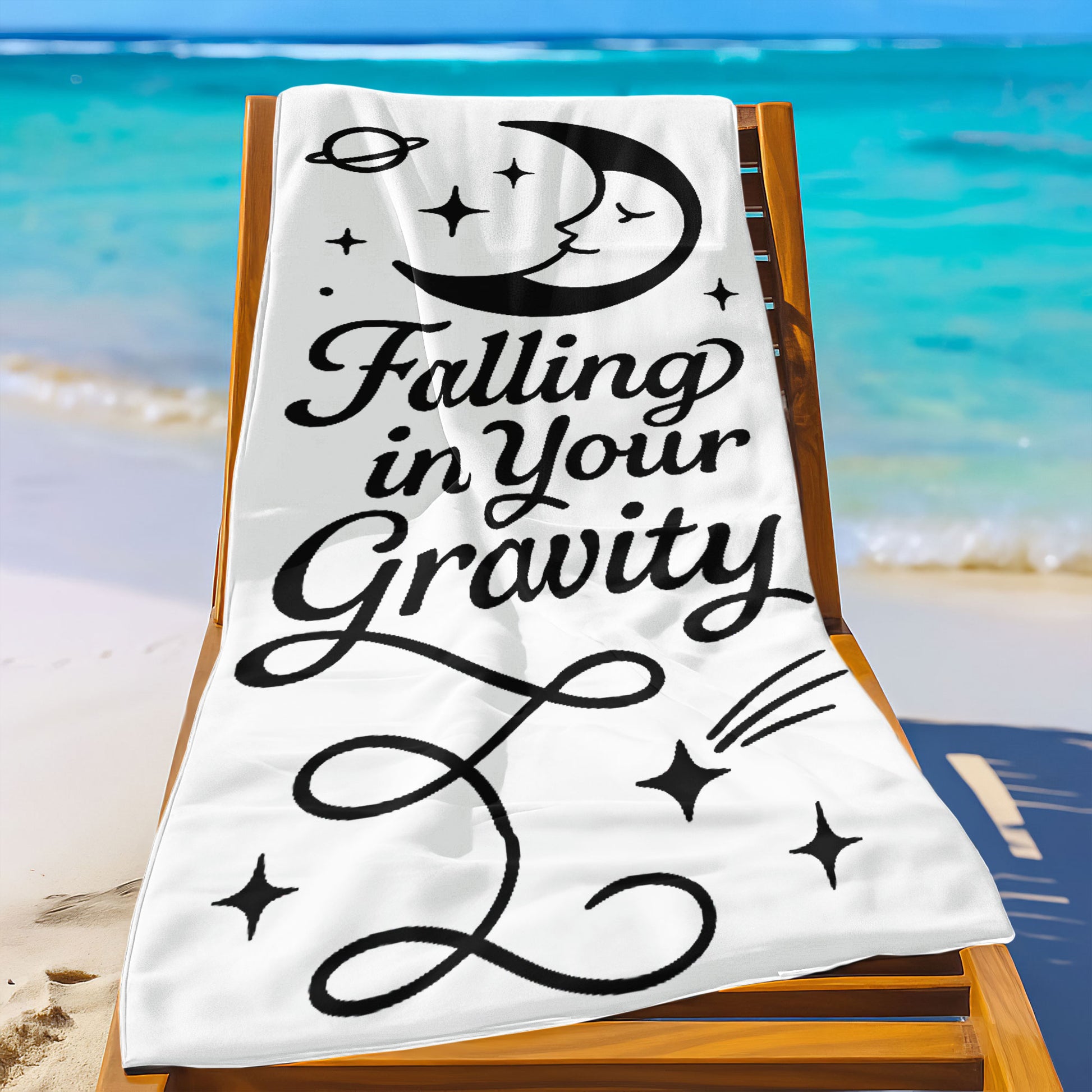 Two people holding up custom white beach towels with black sun and moon designs and romantic phrases, "Burning with Love" and "Falling in Your Gravity," on a sunny beach.