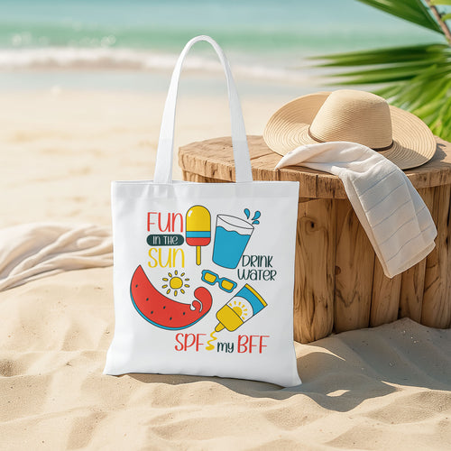 White beach tote bag with colorful 'Fun in the Sun' graphics including watermelon, popsicle, water, sunglasses, and sunscreen