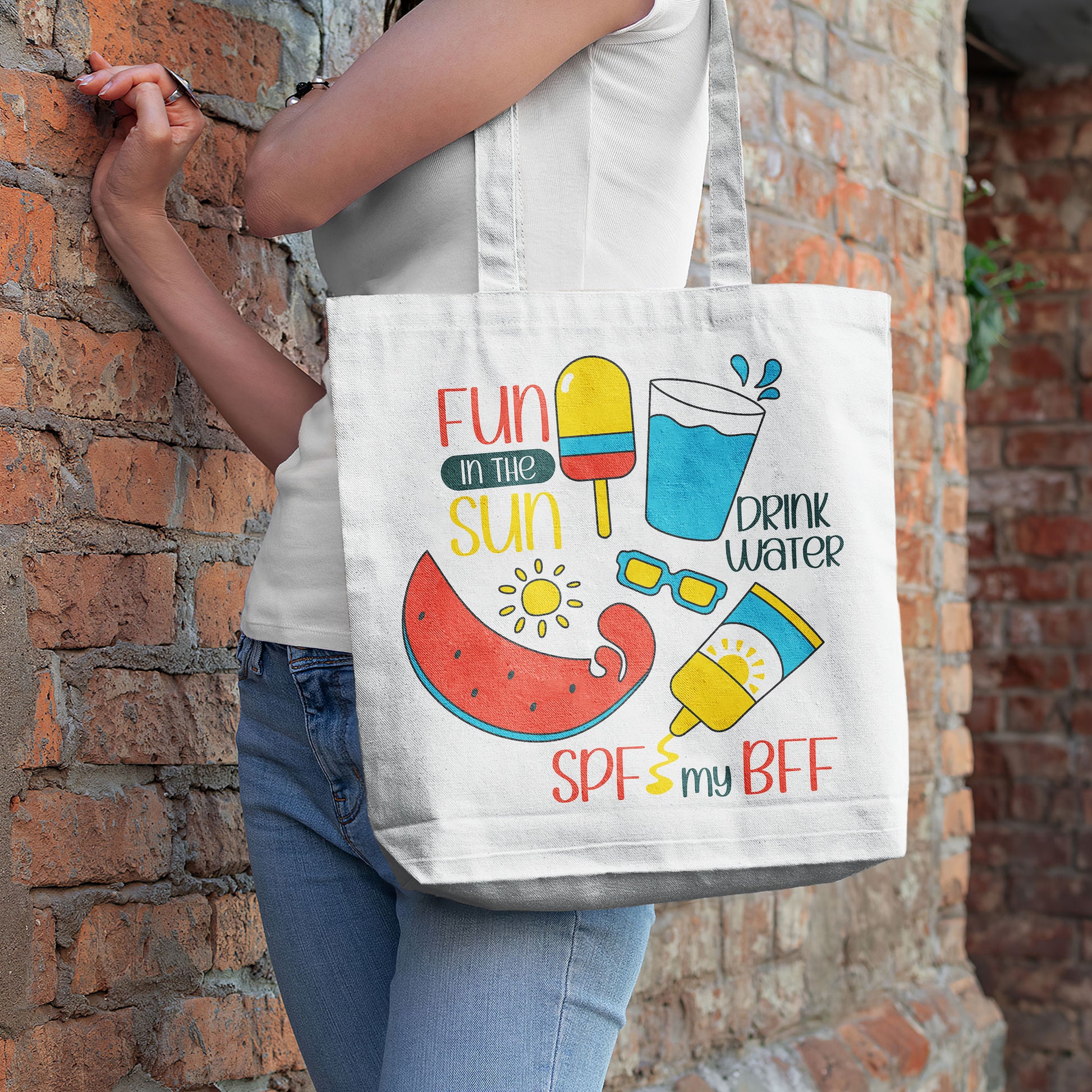 White beach tote bag with colorful 'Fun in the Sun' graphics including watermelon, popsicle, water, sunglasses, and sunscreen