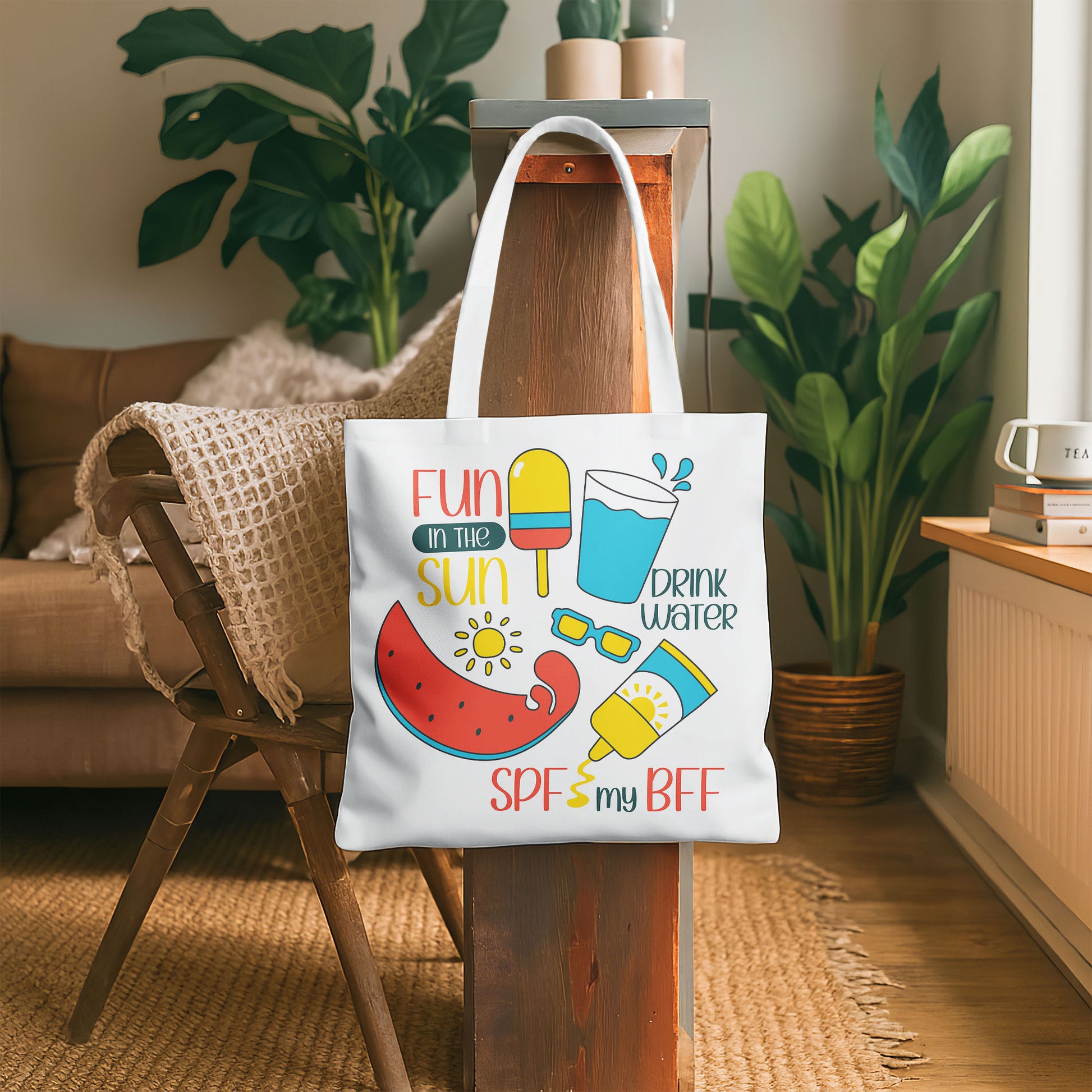 White beach tote bag with colorful 'Fun in the Sun' graphics including watermelon, popsicle, water, sunglasses, and sunscreen