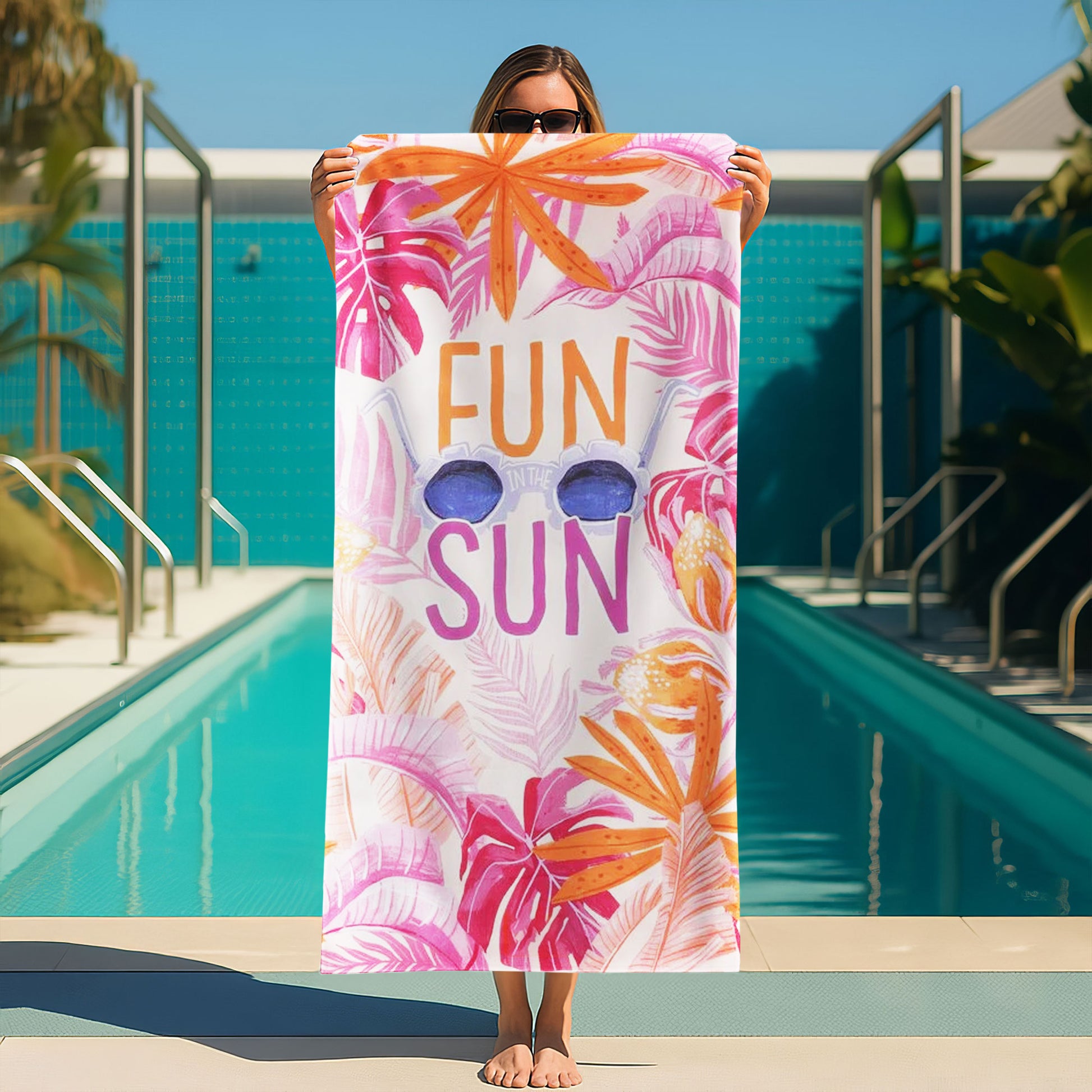"Fun in the Sun" Tropical Leaves Beach Towel with a white background, vibrant pink and orange tropical leaves, large "FUN IN THE SUN" text, and sunglasses on a beach with ocean background.
