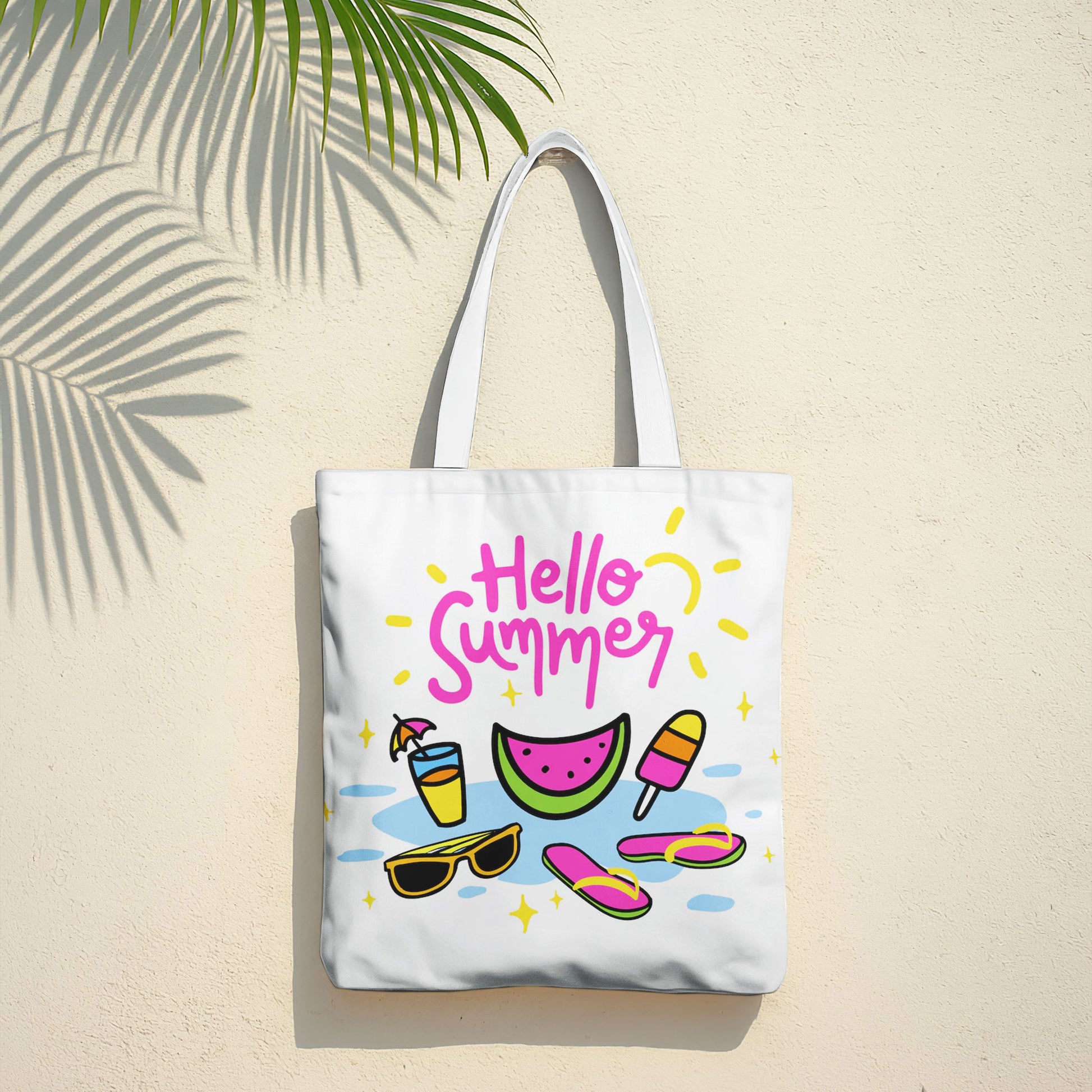 Close-up of a white tote bag featuring a bright, playful summer design with various beach and vacation items.