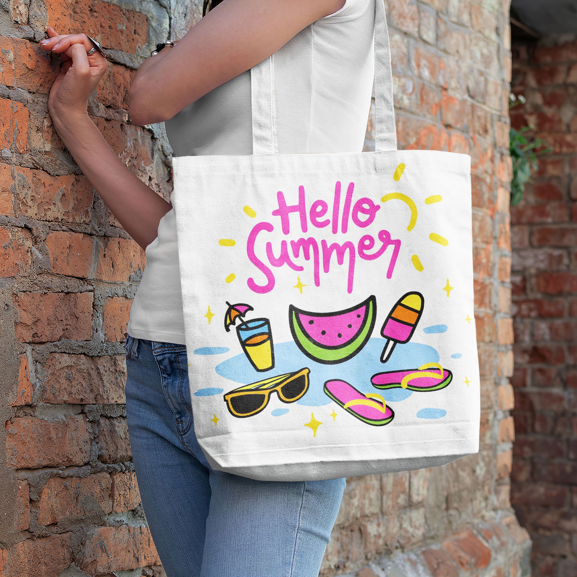 Close-up of a white tote bag featuring a bright, playful summer design with various beach and vacation items.