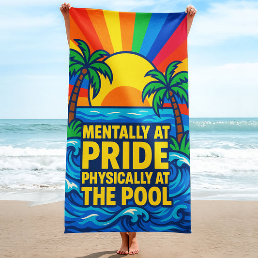 A person holding up a colorful beach towel on a sunny beach, featuring a rainbow sunset, palm trees, and the text "MENTALLY AT PRIDE PHYSICALLY AT THE POOL".