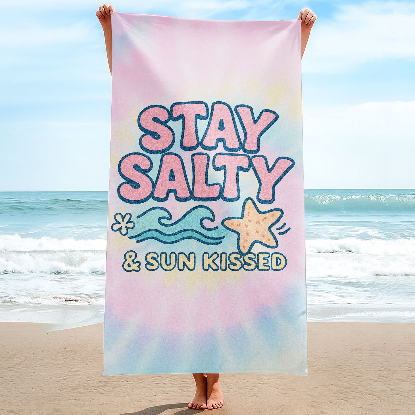 "Stay Salty & Sun Kissed" Tie-Dye Beach Towel with pastel pink, yellow, and blue background, large text "STAY SALTY & SUN KISSED", waves, and a starfish on a beach with ocean background.