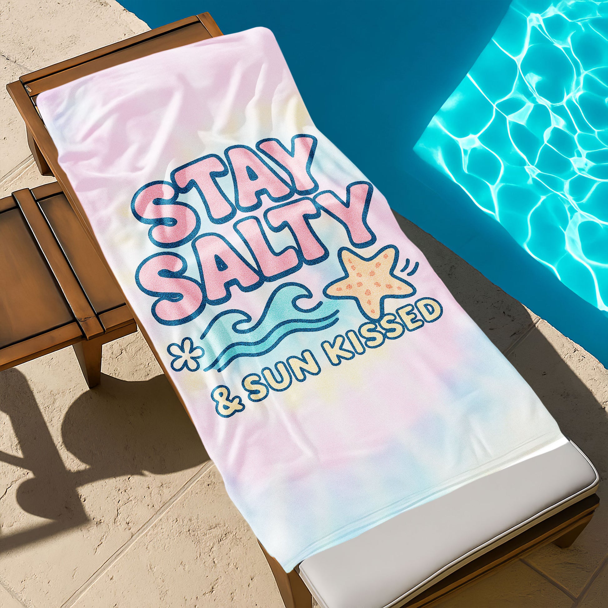 "Stay Salty & Sun Kissed" Tie-Dye Beach Towel with pastel pink, yellow, and blue background, large text "STAY SALTY & SUN KISSED", waves, and a starfish on a beach with ocean background.